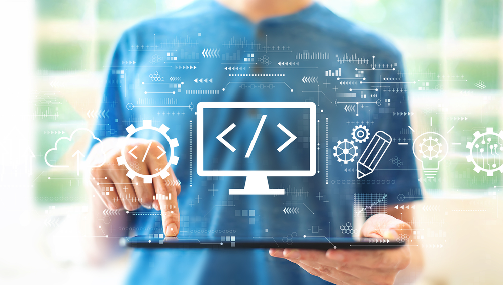 Web development concept with young man using a tablet computer